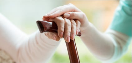 Close-up-photo-of-a-female-caregiver-and-senior-woman-holding-hands.-Senior-care-concept.